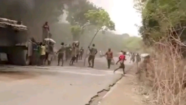 Youth Caught On Camera Looting Burning Truck in Benue
